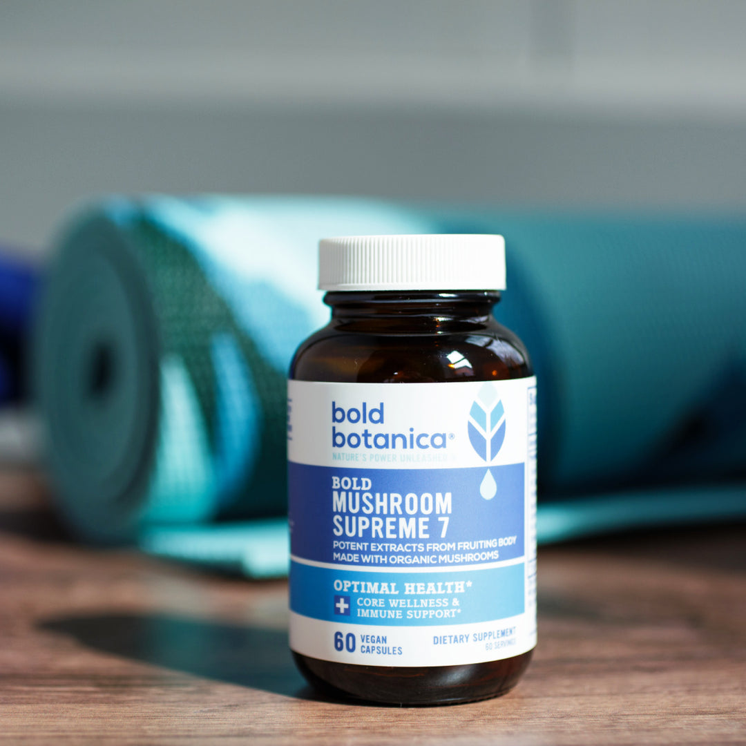Bottle of Bold Mushroom Supreme 7 extract capsules in front of a yoga mat