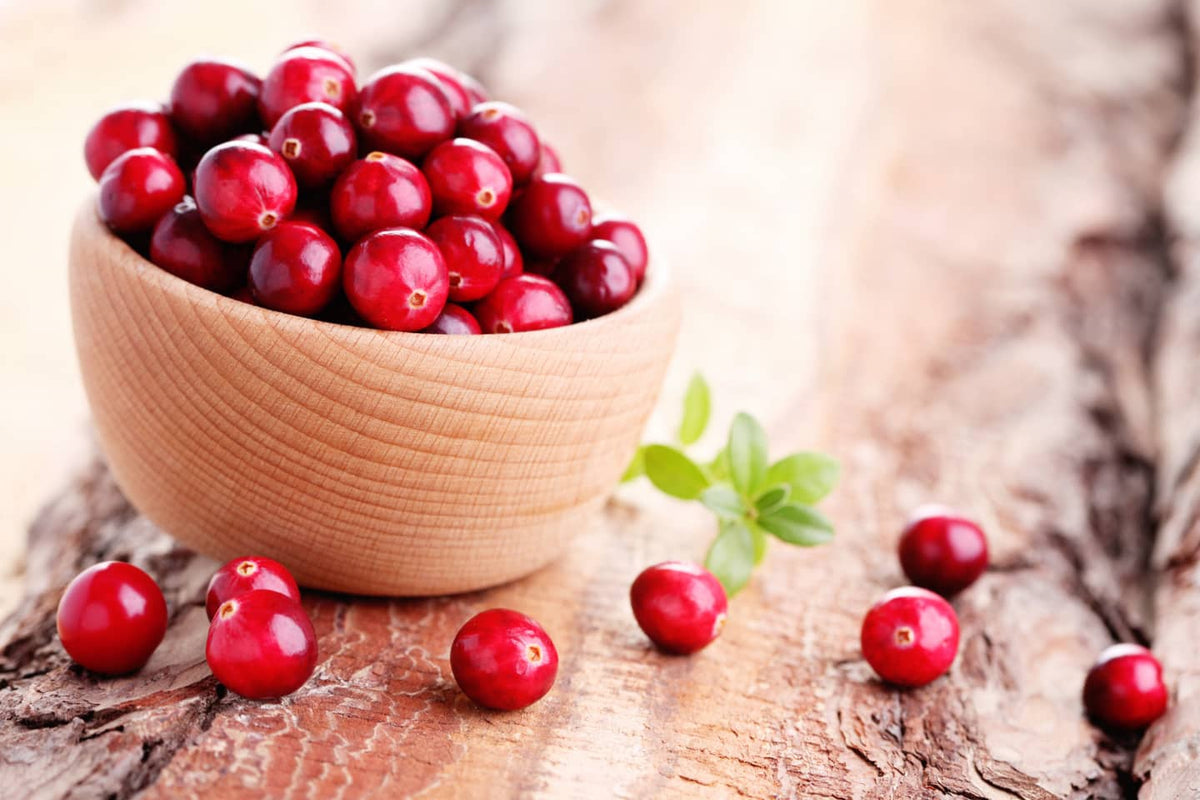 cranberries in a bowl and on a table