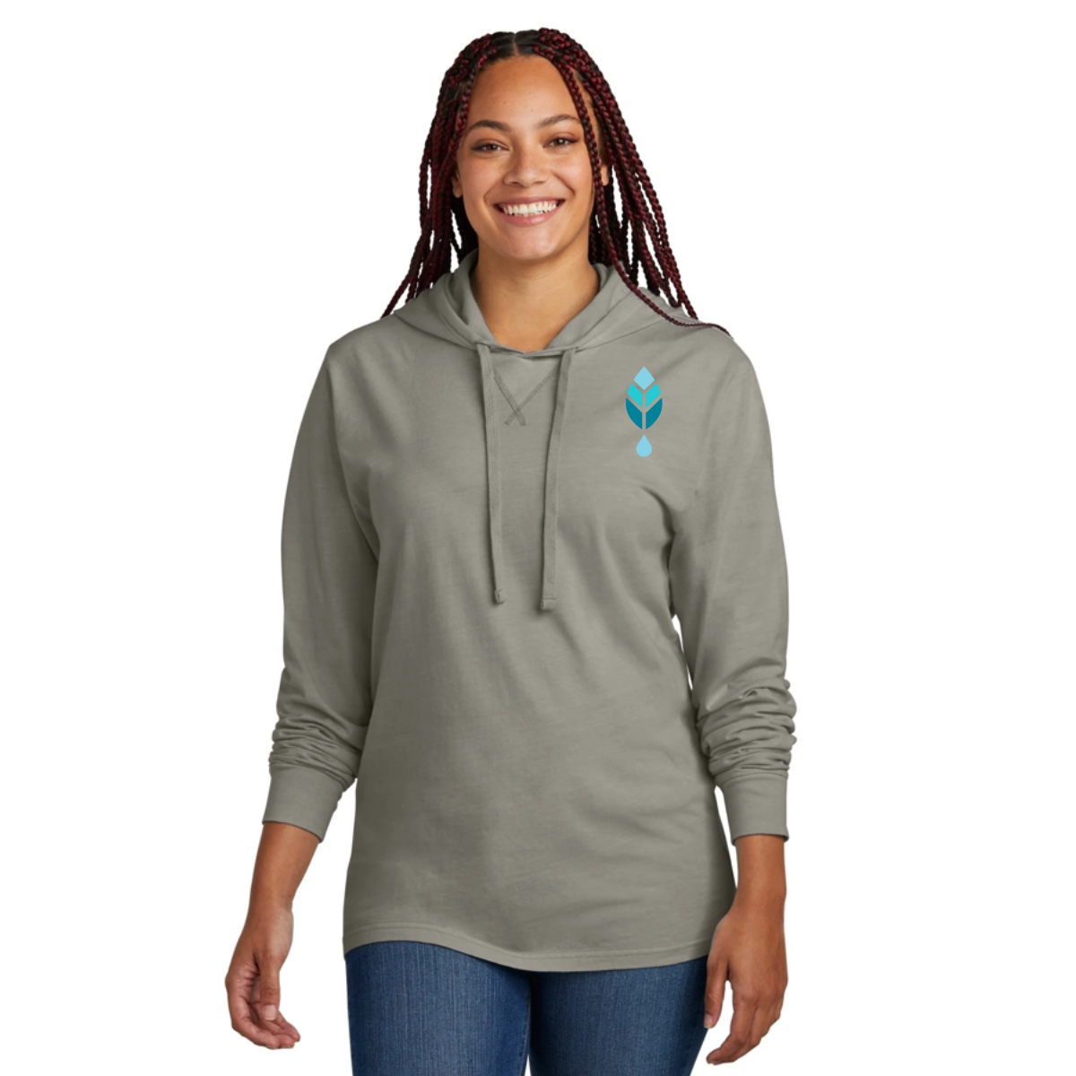 woman wearing gray bold botanica hoodie with blue logo to left chest and jeans against a white background