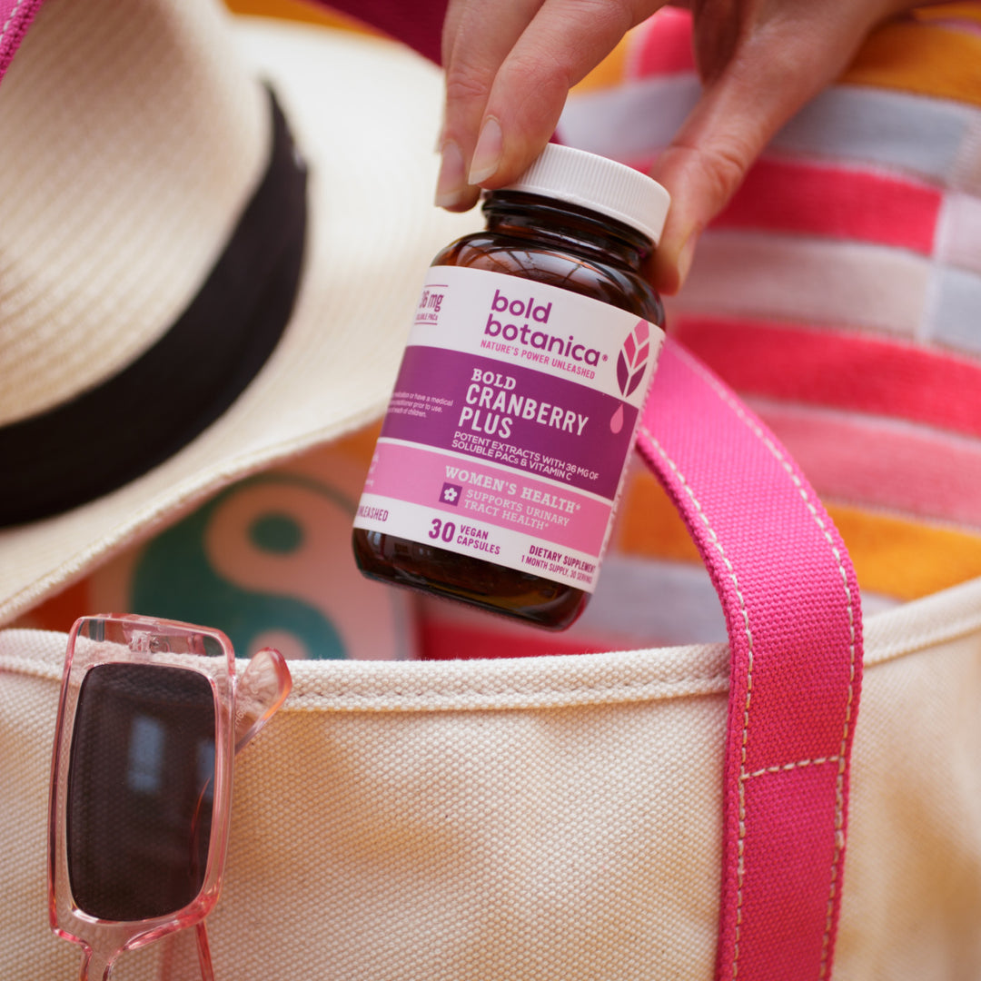 Bottle of cranberry supplements being put into a bag